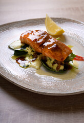 Salmon steak with sauce. Vegetable garnish.