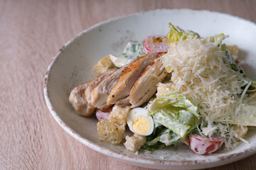 Caesar salad close-up on a beige background