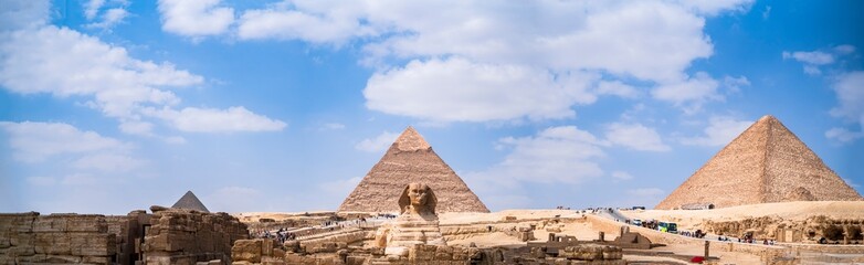 The three pyramids of cairo and the sphinx in a panoramic photograph. Photograph taken in Giza, Cairo, Egypt. - obrazy, fototapety, plakaty