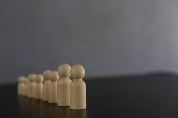Wooden puppet group with organization leaders working as a team Meeting the business team to...