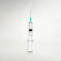 Disposable medical syringe with needle on white background. 