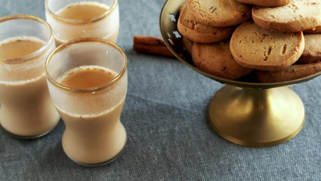 Masala chai with jeera cumin biscuits cookies. Table spin.