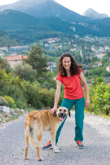 A woman walks shepherd dog