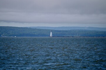 A light house with a red cap on the waters of Lake Superior near Ashland Wisconsin under a blanket...