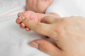 baby's hand holds mom's hand. first days of life. mather and baby
baby hand