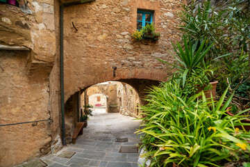 Fototapeta na wymiar An alley with brick arches in the town of Campiglia Marittima Tuscany Italy