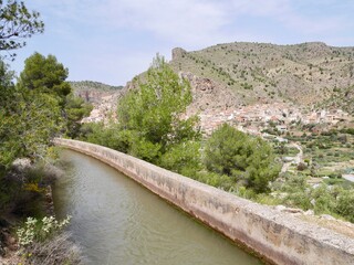 Fototapeta premium Irrigation system in Sierra mountains, charming town Ayna in the background. Albacete, Castile La Mancha, Spain.
