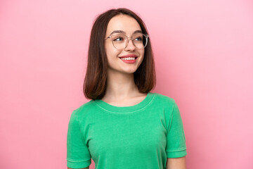 Fototapeta premium Young Ukrainian woman isolated on pink background With glasses with happy expression