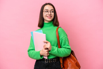 Young student Ukrainian woman isolated on pink background looking side - obrazy, fototapety, plakaty