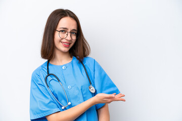 Young nurse Ukrainian woman isolated on white background presenting an idea while looking smiling...