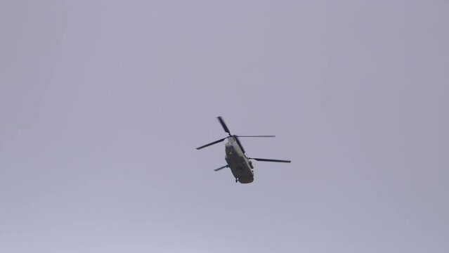Chinok helicopter flying overhead in the sky during military training in Utah.