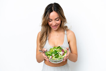 Young caucasian woman isolated on white background holding a bowl of salad with happy expression