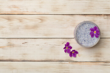 Natural scrub in container on wooden background, top view