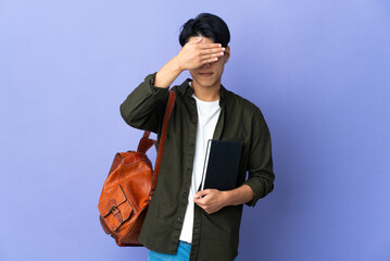 Young student woman isolated on purple background covering eyes by hands. Do not want to see...