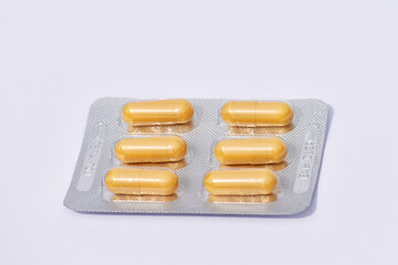 Medical capsules and pills on white background