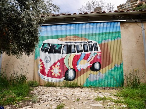 Vintage camper van graffiti on garage door in charming mountain town Ayna, Albacete, Castile La Mancha, Spain, 14.04.2022.
