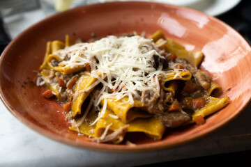 Homemade pasta with grated cheese in a bowl