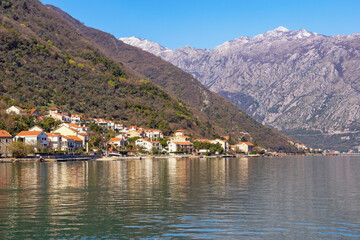 Beautiful Mediterranean landscape. Montenegro, Adriatic Sea. View of Kotor Bay and small seaside town of Stoliv at foot of mountains