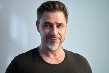 Happy older good looking casual man at home, smiling. Portrait of mid adult, mature age man, Isolated on white.