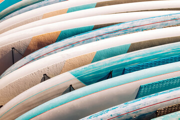 Close-up of colorful paddle boards for rent. - obrazy, fototapety, plakaty