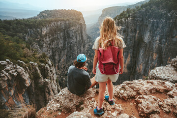 Couple hiking together travel hiking healthy lifestyle active summer vacations outdoor man and woman with backpack tourists on cliff Tazi canyon in Turkey - obrazy, fototapety, plakaty