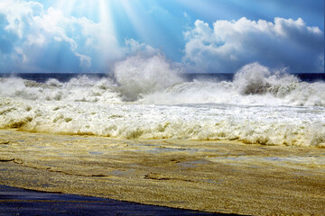 Heavy violent dramatic surf waves crashing on secluded black lava sand beach, misty sea spray foam, sun backlight rays clouds - Cobquecura Piedra De La Loberia, Chile, Pacific coast