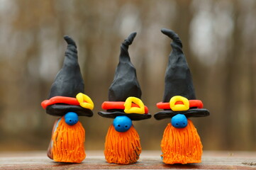 Three dwarfs in a festive hat and a red beard. Halloween decorations.