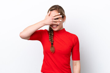 Young caucasian woman isolated on white background covering eyes by hands and smiling