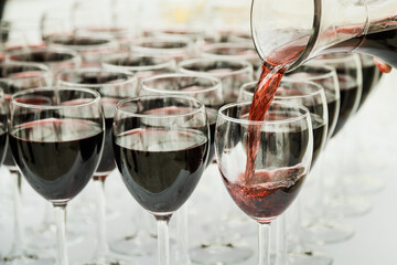 Red wine pouring into a wine glass. Shallow depth of field.