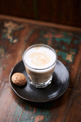 Coffee with milk on rustic wooden background. Soft focus.	