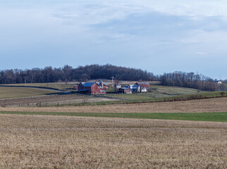 Fototapeta na wymiar Amish Farm in a Valley Surrounded by Fields and Trees | Holmes County, Ohio