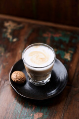 Coffee with milk on rustic wooden background. Soft focus.