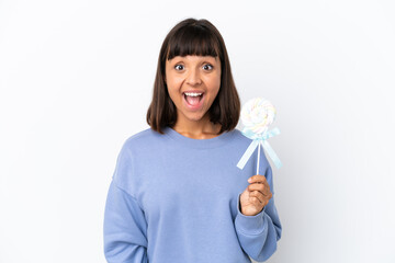 Young mixed race woman holding a lollipop isolated on white background with surprise facial expression