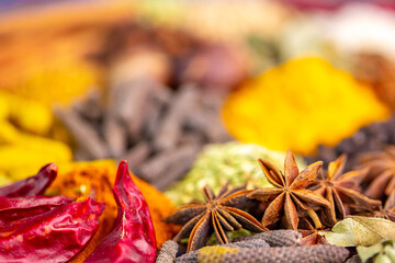 Various spices, peppers and herbs close-up top view. Eastern spice market. A set of peppers and spices for cooking.