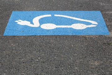 Electric car charging symbol on a parking