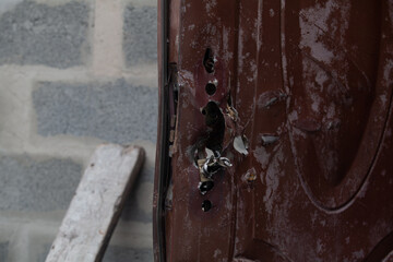 Metal front door shot from a machine gun