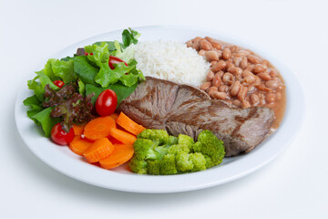 Rice with meat, beans, vegetables and salad
