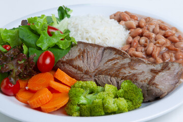 Rice with meat, beans, vegetables and salad