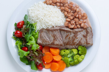Rice with meat, beans, vegetables and salad