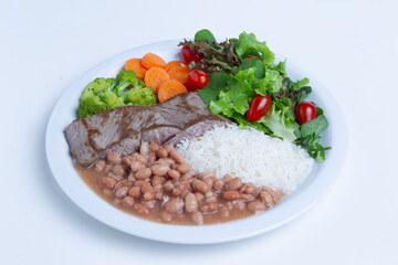 Rice with meat, beans, vegetables and salad