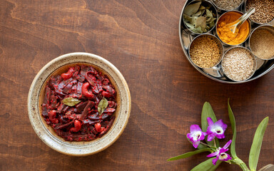 Grated beetroot curry with coconut and cashews with spices in Masala Dabba spice box. Indian...