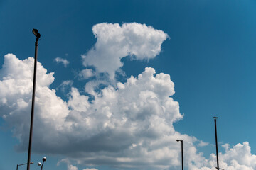 Bright beautiful white clouds against the midday blue sky.