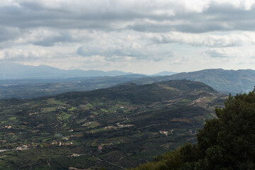 View from above of the beautifull countryside of Crete. Rural landscape, olive groves and country roads.