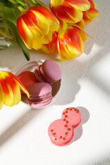 sweet pasta in the form of the number eight on the table. There are other macaroons nearby. Top view