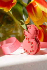 sweet pasta in the form of the number eight on the table under the tulips