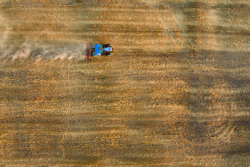 Fototapeta na wymiar Aerial view of agricultural parcels of different crops. Hay bale fields and farmlands of Lithuania. Harvesting machinery or equipment.