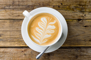 coffee cappuccino with pattern on wooden table top view