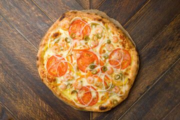 pizza with shrimps, cheese and tomatoes top view on the board