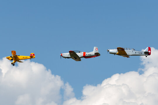 Payerne, Switzerland - September 6, 2014: B&uuml;cker B&uuml; 131 HB-UVM leading Pilatus P-3 N848AD and Pilatus P-2 HB-RAZ in a formation of Former Swiss Air Force training aircraft.