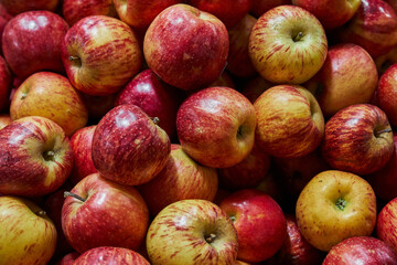 Stacked apples placed on a shelf for sale within a market